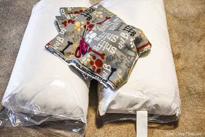 This DIY Dog Bed is super easy to make with step by step instructions using pillows and fleece. It is so easy to remove and clean. Supplies for dog bed- fleece, pillows, thread, pins, measuring tape, pen, scissors.