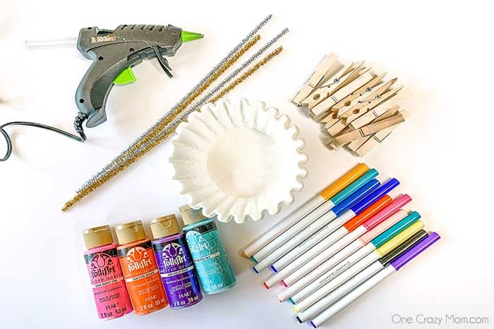 With just a few simple dollar store supplies, you can make a whimsical Clothespin Butterfly. It is the perfect craft to do with the kids and so easy. Supplies - clothespin, filters, pipe cleaners, markers, paint, pipe cleaners.