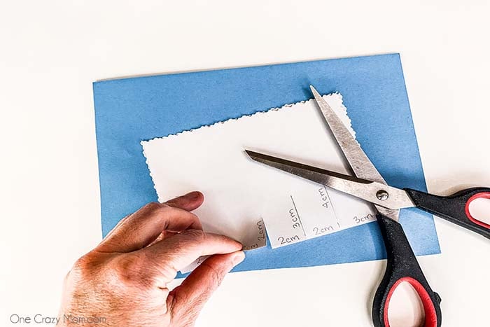 Lines being cut with scissors. 