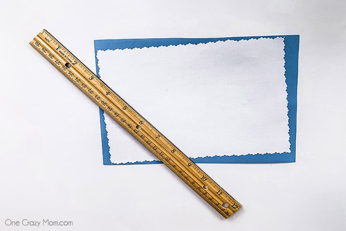 Paper layered on top of each other next to a ruler. 