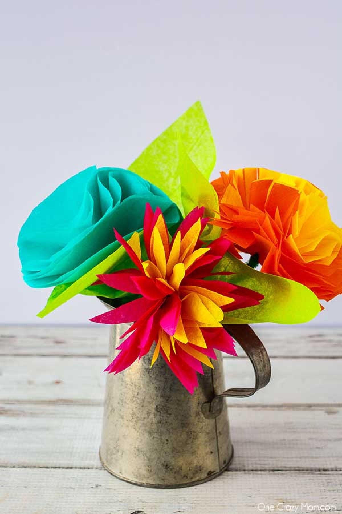 Tissue paper flowers are so simple to make and you can use any color combination you like. These are perfect for room decor, parties and more! Vase of tissue paper flowers.