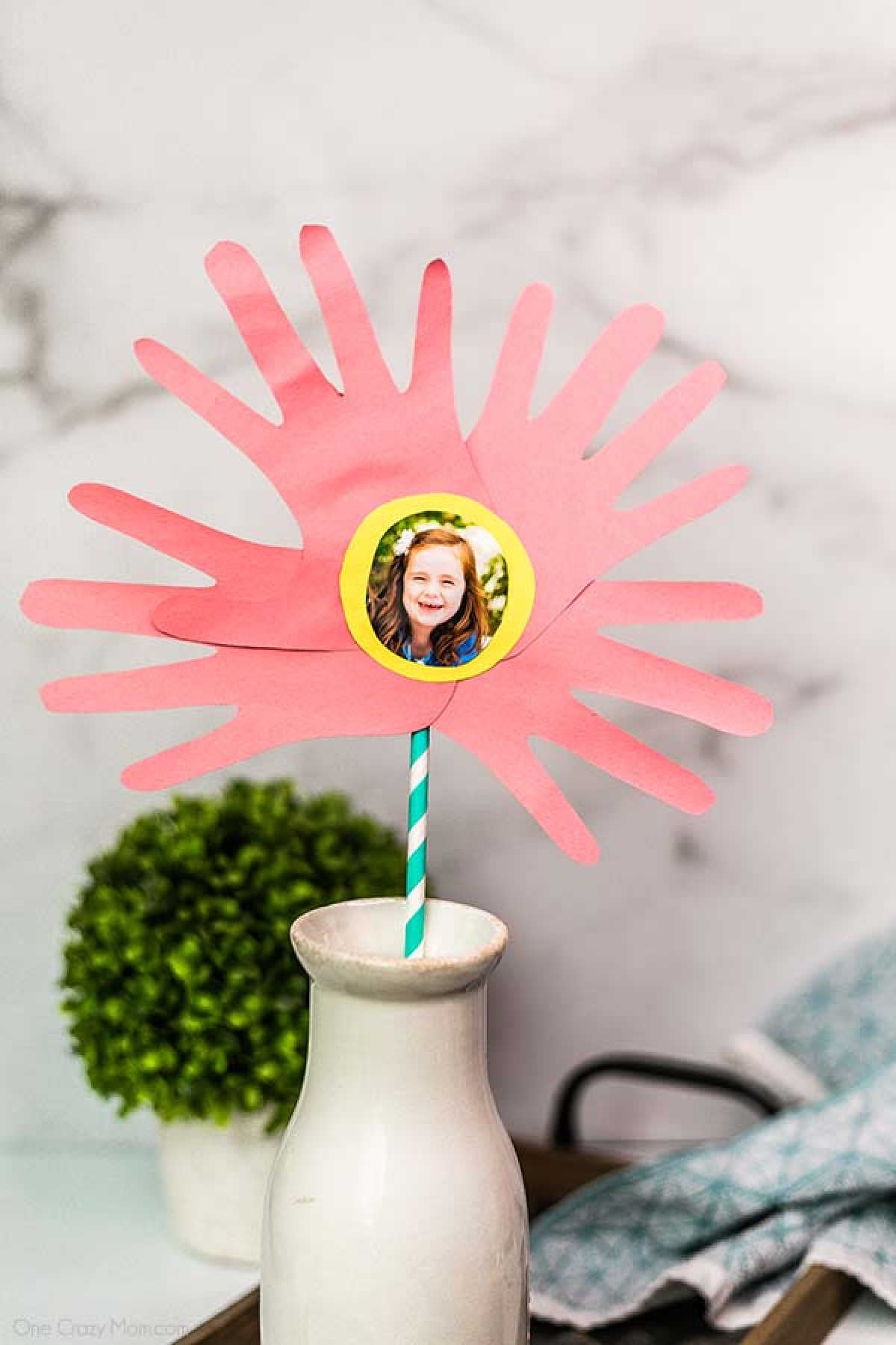 Handprint Flowers are perfect to make for Mother's Day, birthdays and more. This gift will be cherished for years to come by Mom, Grandma and others. Handprint flower in vase.