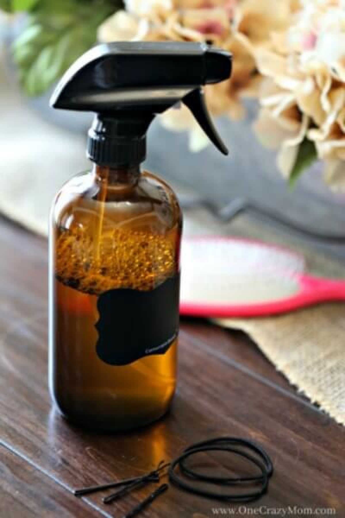 It is so easy to make homemade hair detangler. With only 2 ingredients, this homemade hair detangler recipe is simple and frugal. This easy hair detangler DIY is great for adults and for kids. You’ll love both of these recipes. One is all natural with apple cider vinegar and essential oils! This is the best hair detangled diy kids essential oils recipe. That is great for straight and curly hair! #onecrazymom #DIYhairdetangler Spray bottle of hair detangler.