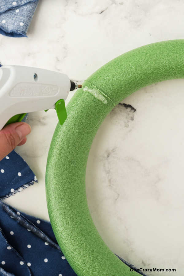 Gluing fabric to wreath.