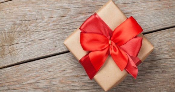 Here are some Valentines Gifts for him that your husband or boyfriend will love. 25 Frugal Valentine's day gifts for him that won't break your bank. Brown box wrapped in red ribbon.