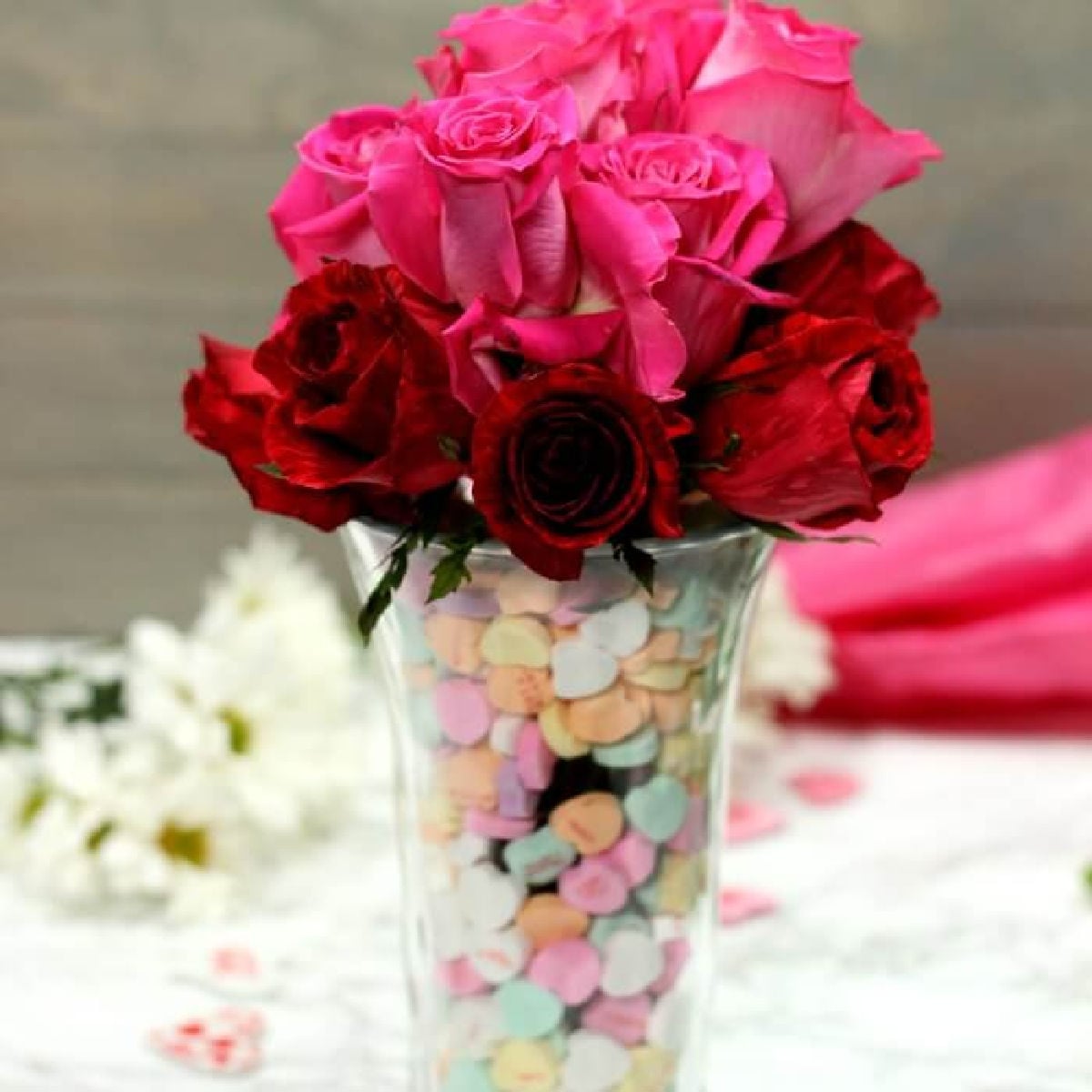 Candy filled vase with roses.