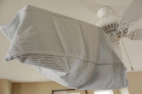 Pillowcase cleaning a fan.