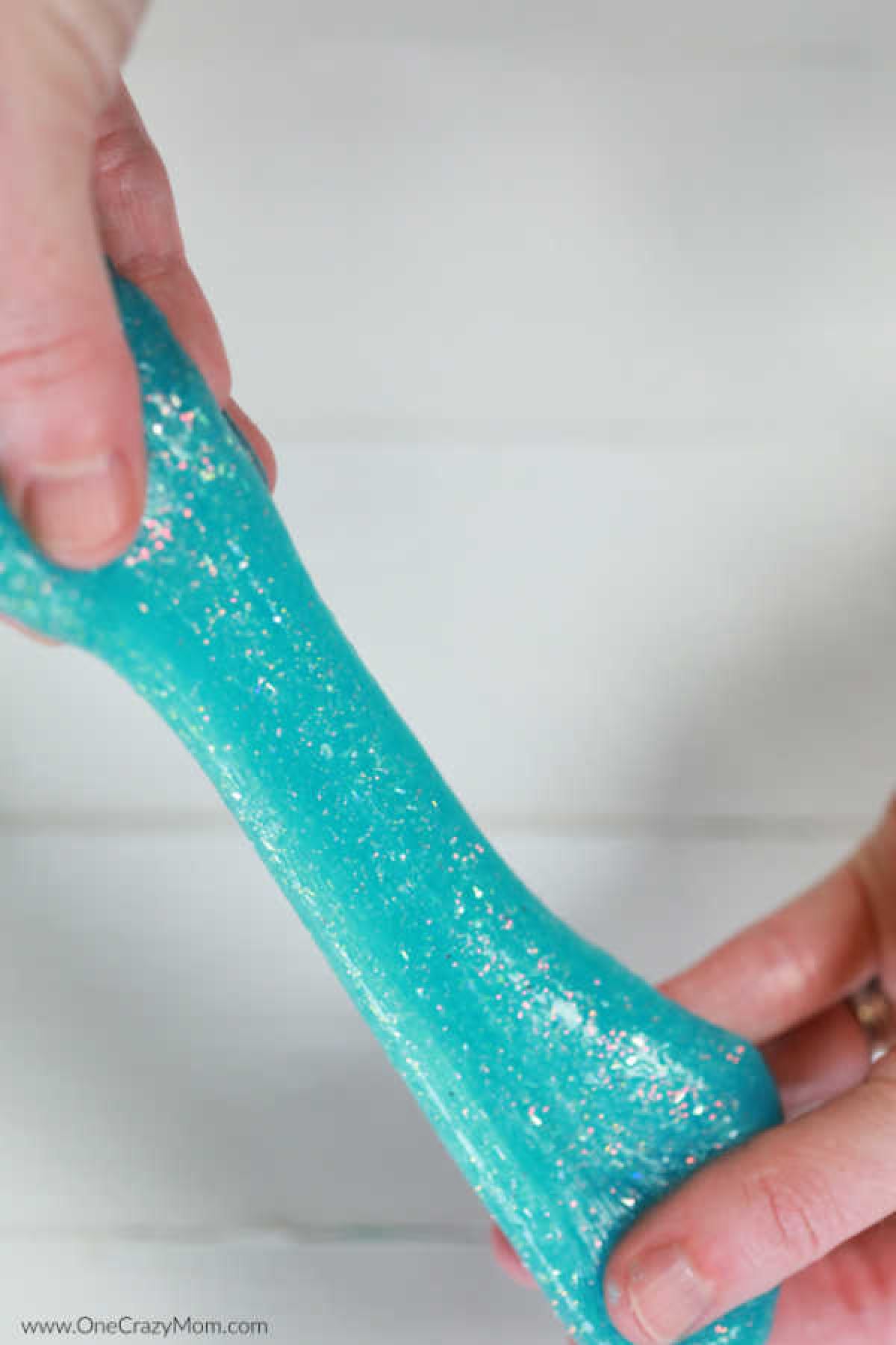 We have a super simple DIY for 2 Ingredient Slime that your kids can make. You can make really cool slime with ONLY 2 ingredients that your kids will love! Slime being stretched.