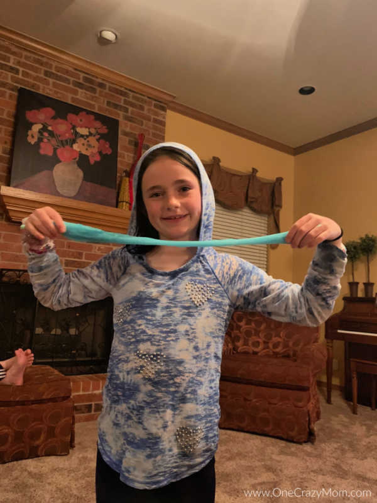 We have a super simple DIY for 2 Ingredient Slime that your kids can make. You can make really cool slime with ONLY 2 ingredients that your kids will love! Slime being played with.