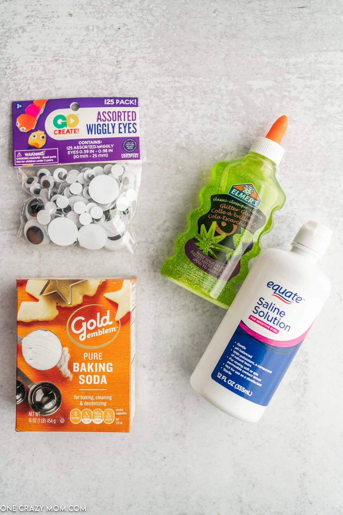 Ingredients for Halloween Slime- green glitter elmer's glue, baking soda, saline solution, googley eyes.