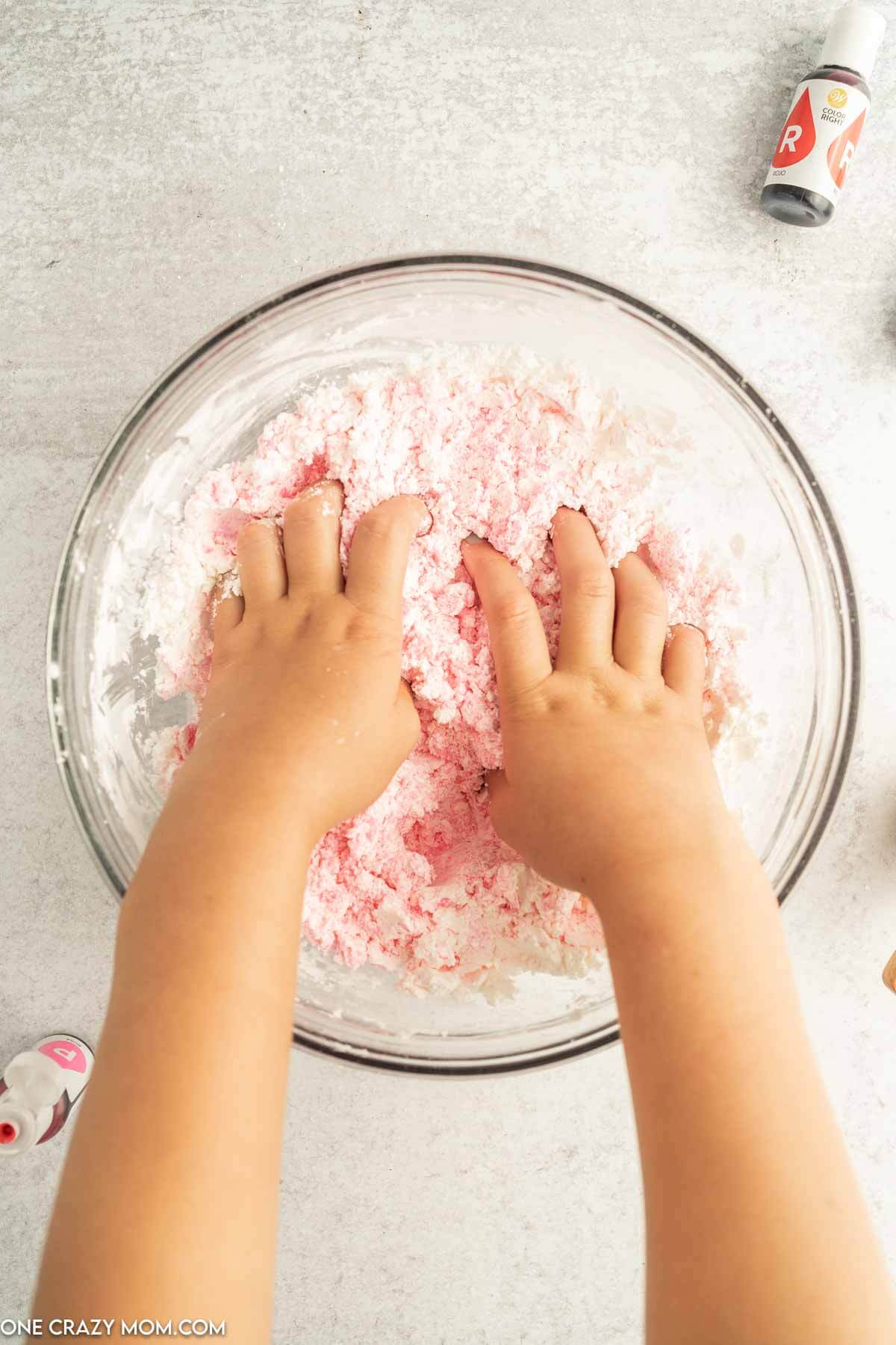 Hands crumbling slime.