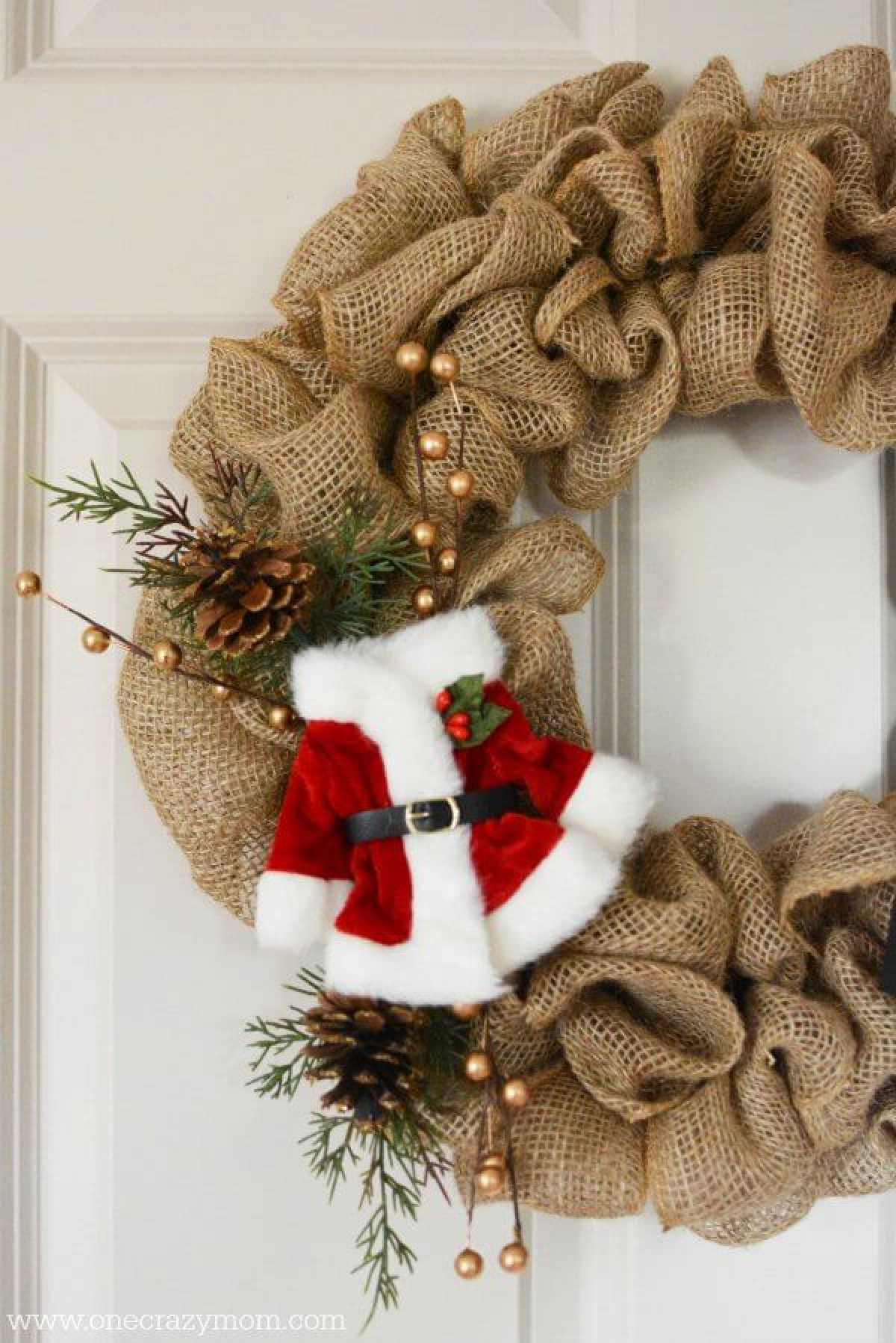 Learn how to make a burlap wreath for Christmas. This burlap Christmas wreath is so simple to make. Christmas burlap wreaths look so festive. Christmas wreath with burlap hanging on door.