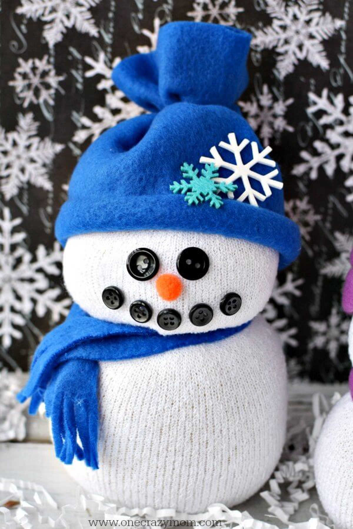 You will love learning how to make sock crafts! Find out how to make a snowman made out of socks. This DIY Sock Snowman craft is so cute and simple to make! Sock Snowman created and decorated.