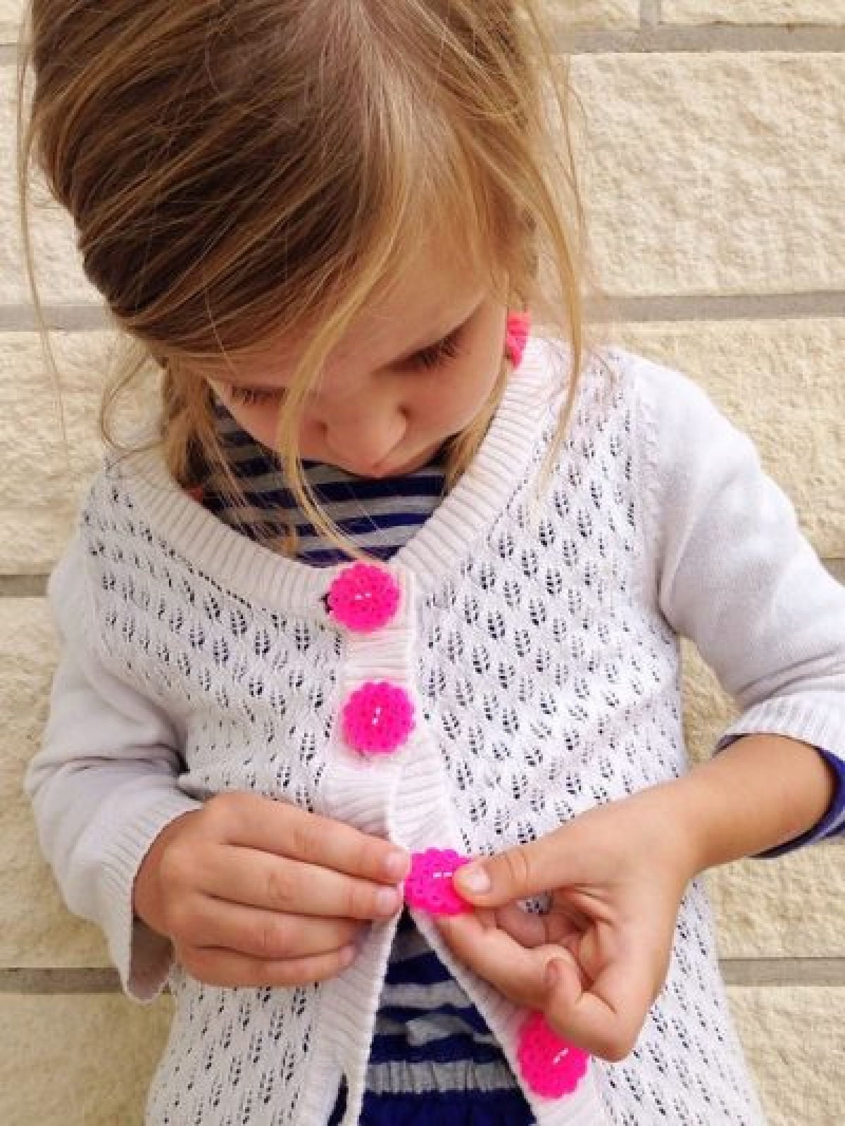 Perler bead crafts are so much fun and we have over 15 easy perler bead ideas. Choose from picture frames, magnets and so much more. Buttons on a sweater.