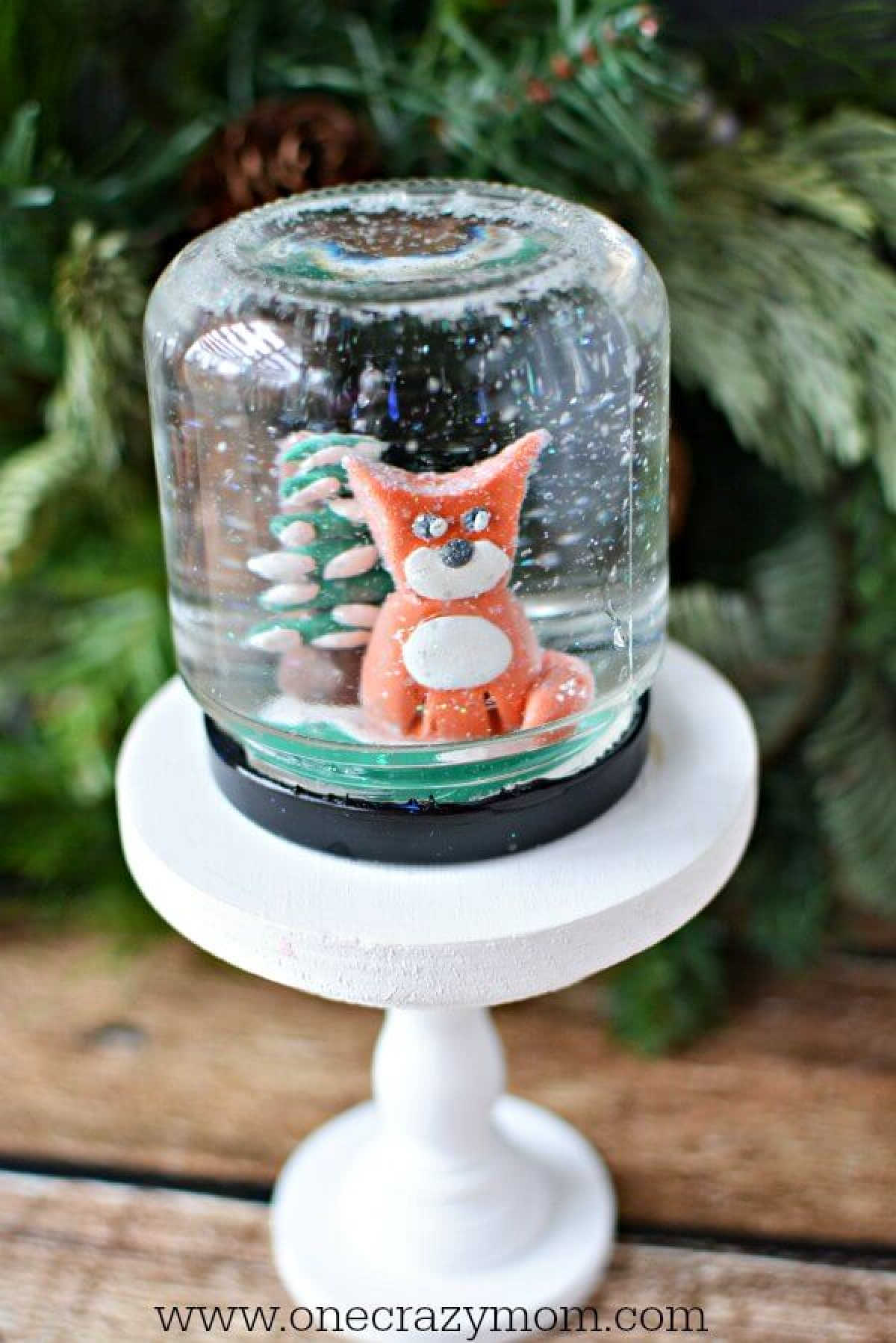 Learn how to make a snow globe craft! This DIY snow globe is so easy and fun to make.Homemade snow globes are so special. Make your own snow globe today! DIY snow globe on a stand.