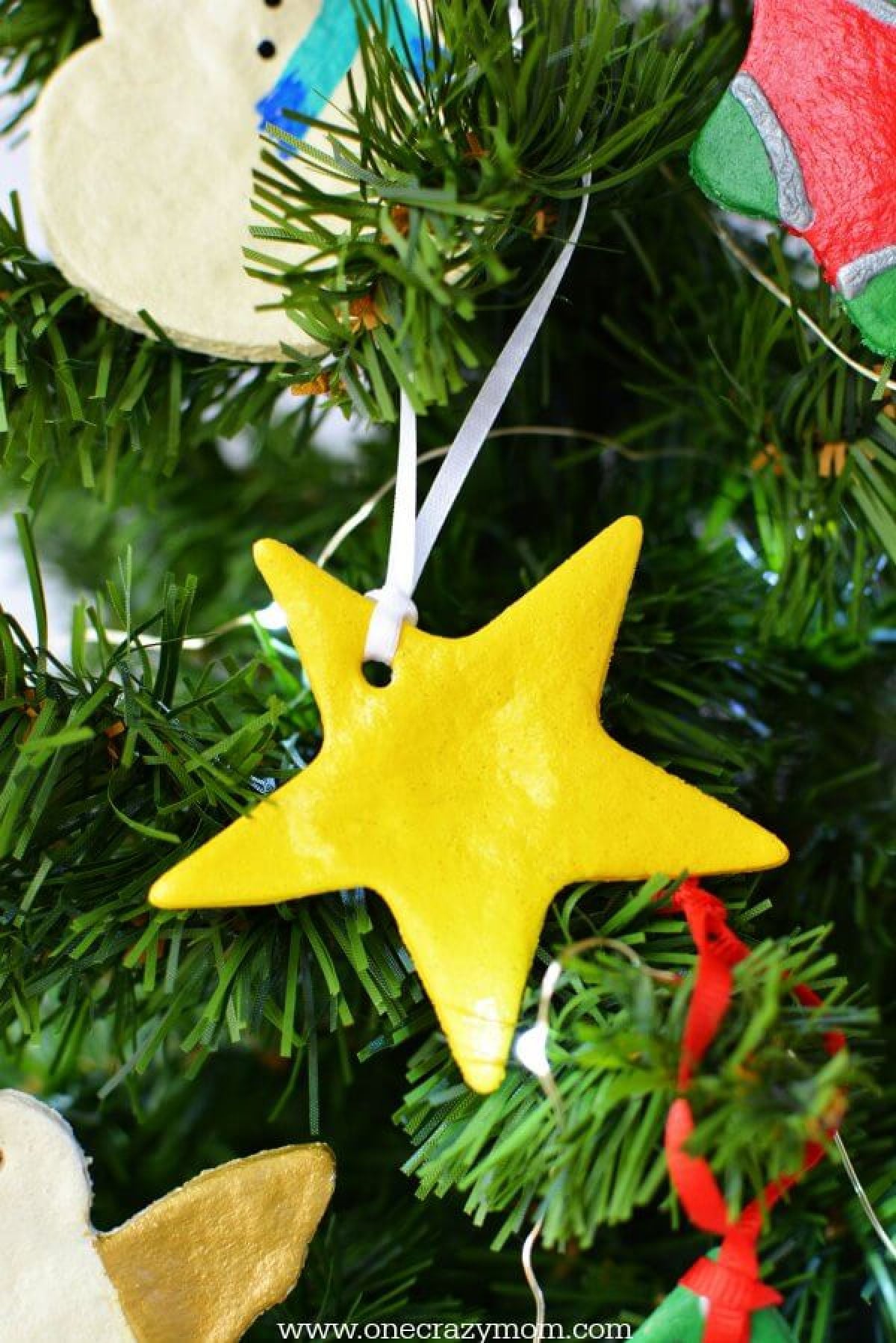 Make special memories with this simple and fun Salt Dough Ornament Recipe for Christmas. Learn how to make salt dough ornaments so easy the entire family can help! This great ornament DIY is perfect for kids. #onecrazymom #christmasornaments #DIYornaments #saltdoughornaments Star ornament on tree.
