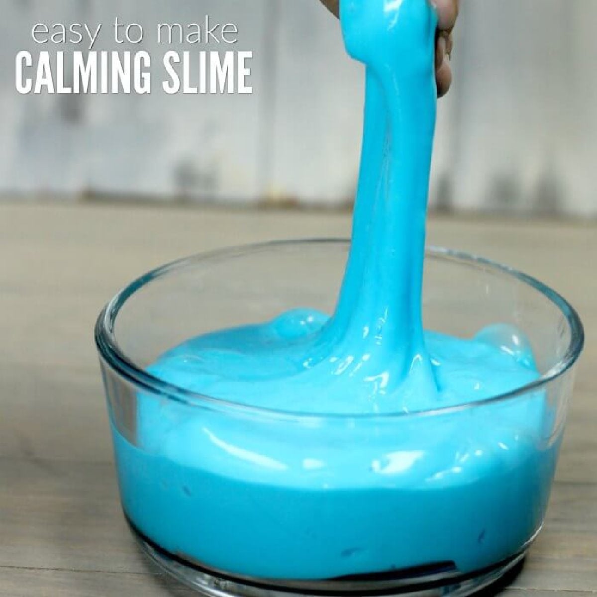 Learn how to make slime for kids that is calming for a great sensory activity. You only need a few simple ingredients for this quick slime recipe. Blue slime in a bowl.