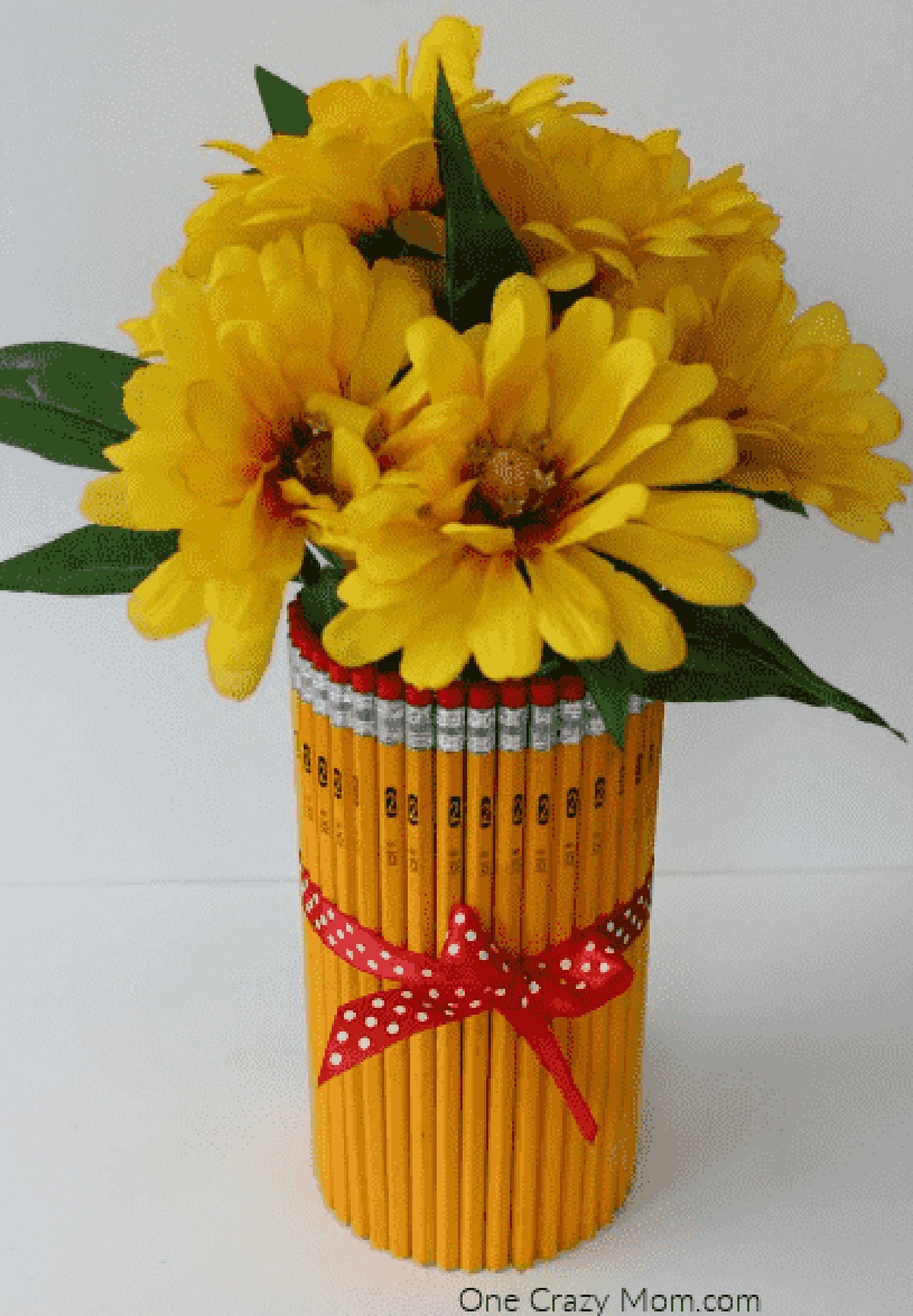 Pencil vase with yellow flowers. 