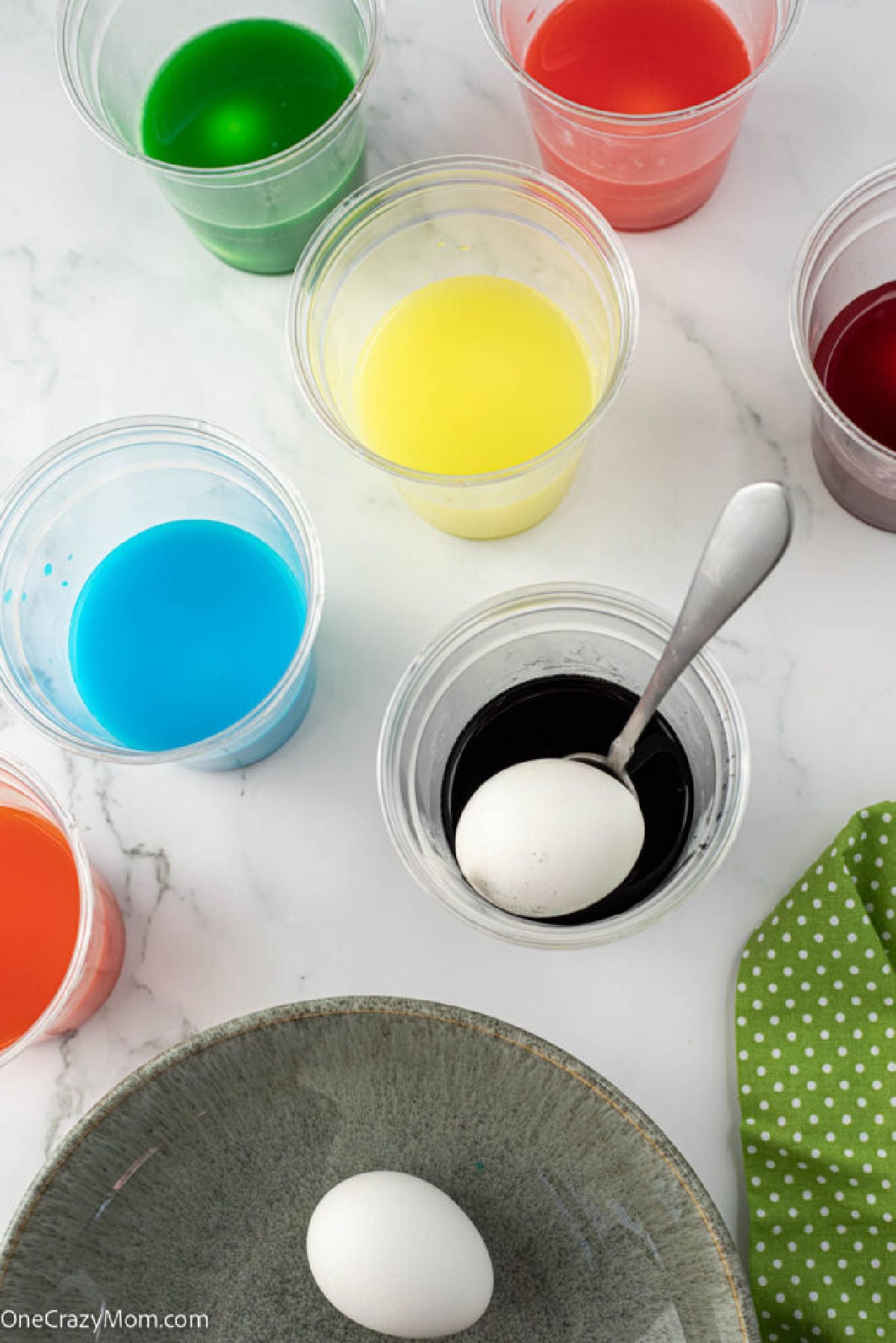 Cups with kool aid mixture for dying.
