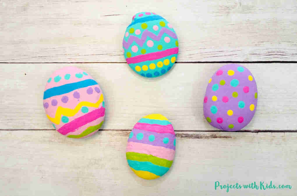 Easter egg rocks painted in vibrant colors.