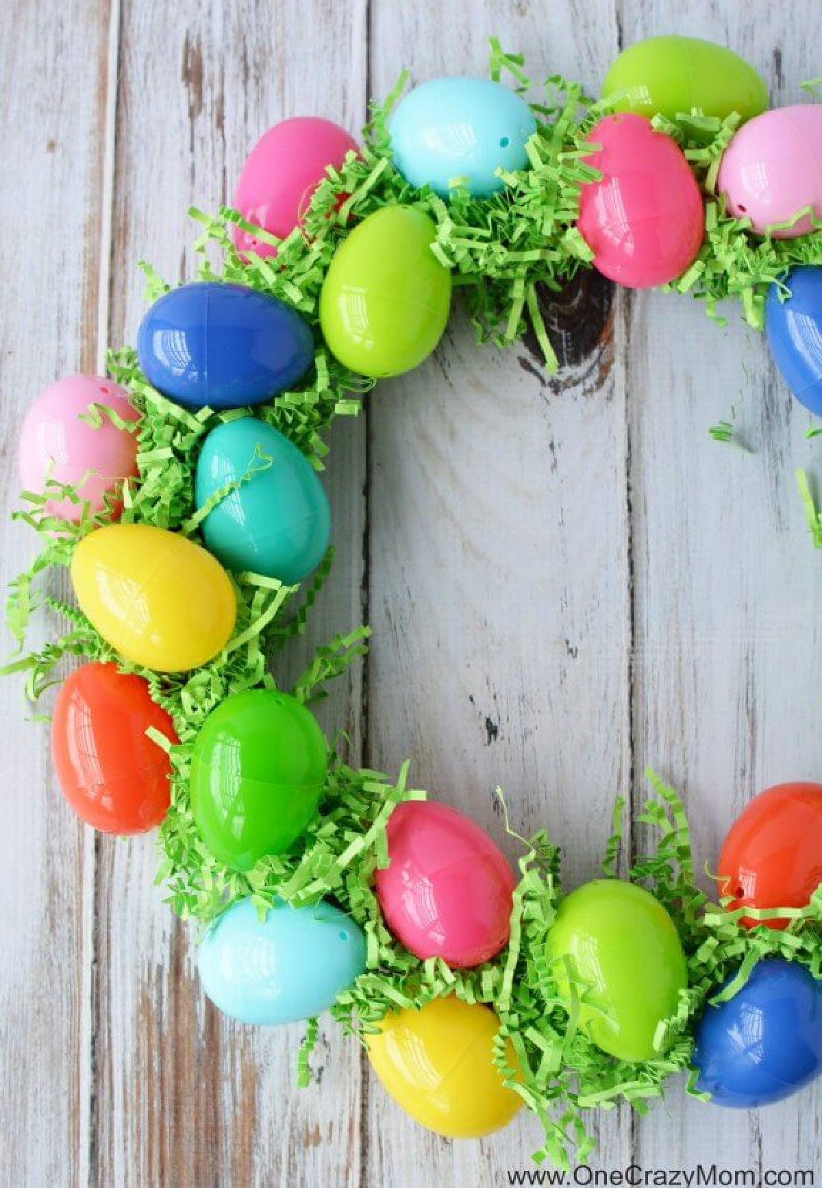 Make this DIY Easter Egg Wreath with items from the dollar store. You will love this easy Easter Egg Wreath DIY. Try this frugal Easter craft today. DIY Easter wreath ready to be used.