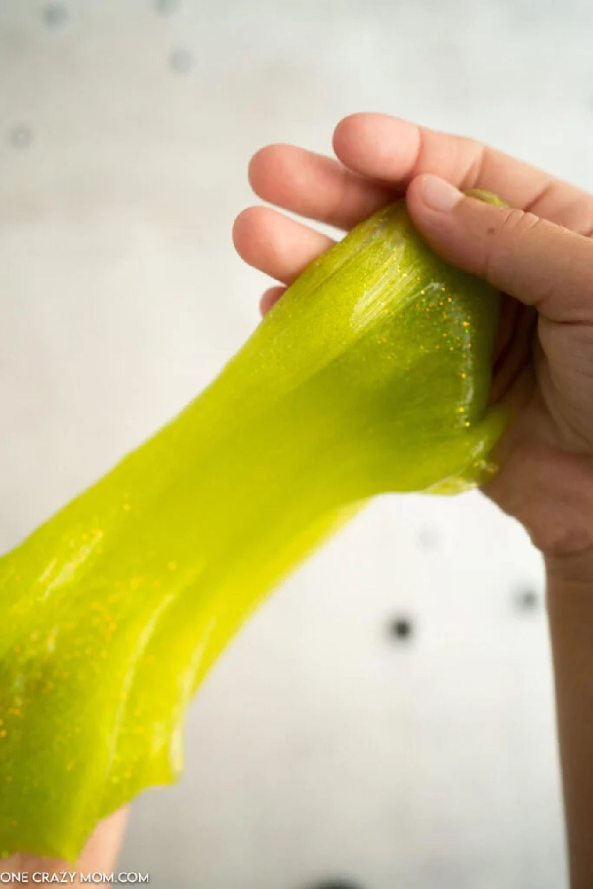 Slime being stretched in someone's hand.
