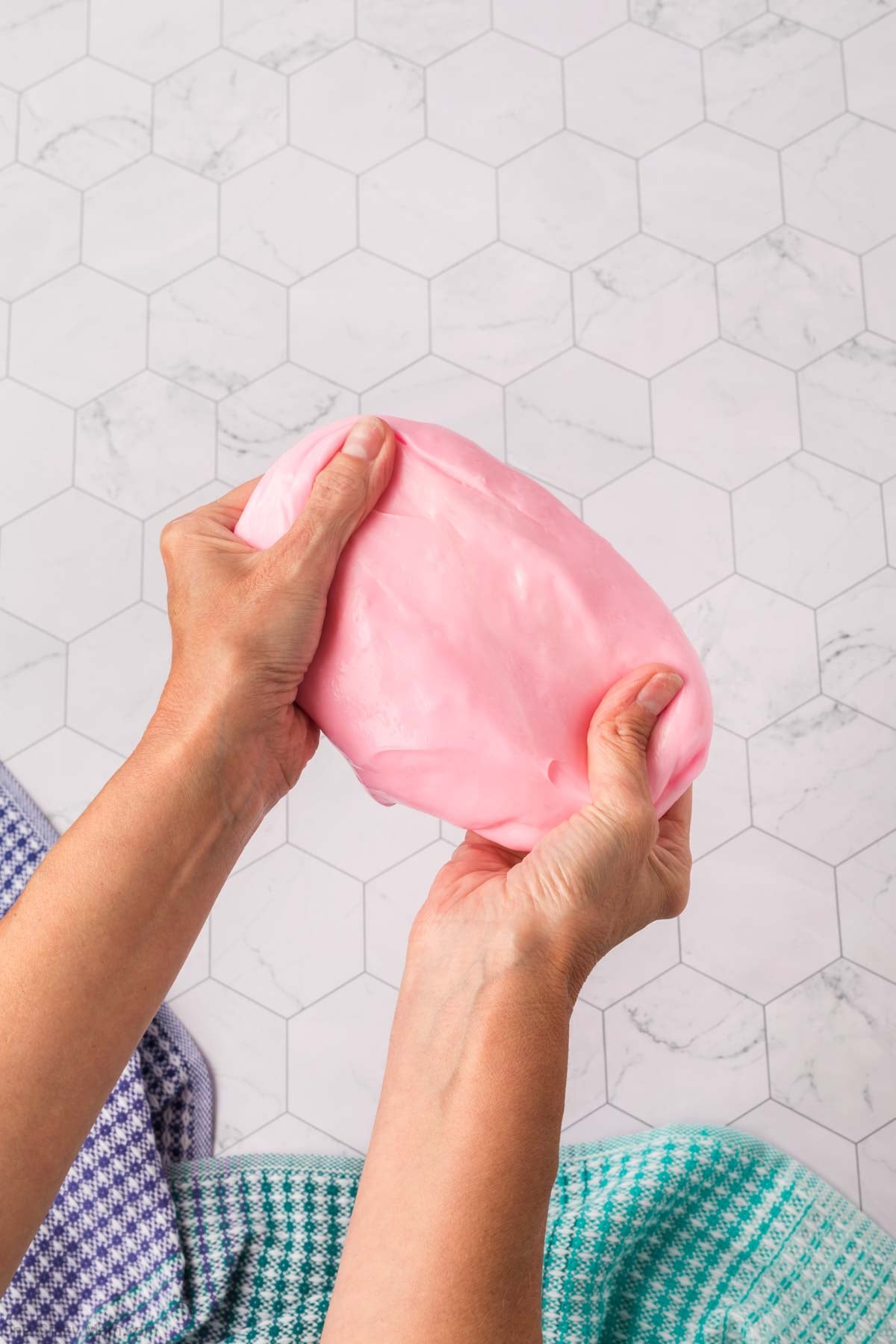 Silly Putty stretched in hands.