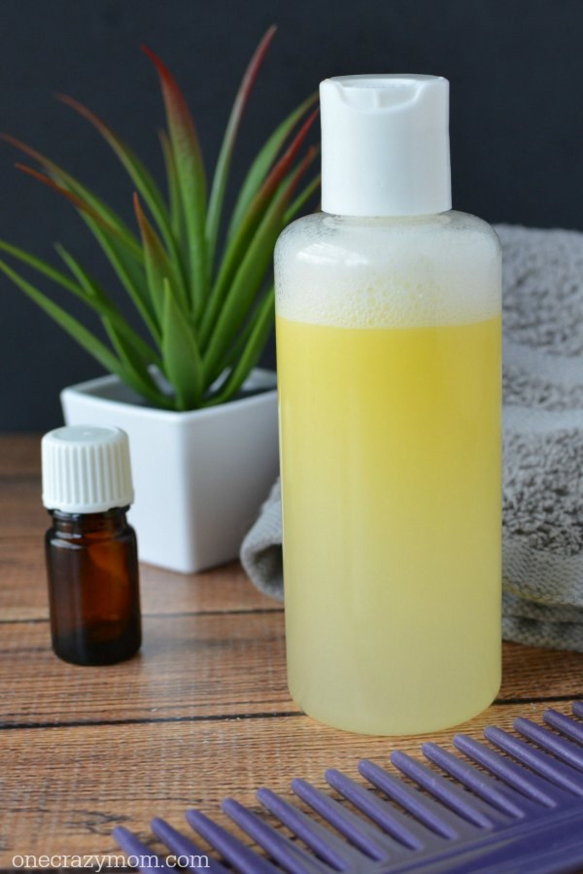 You're going to love this Homemade Dandruff Shampoo. Forget paying way to much at the store when you can make this DIY dandruff shampoo at home. Try it! Shampoo bottle beside a towel.