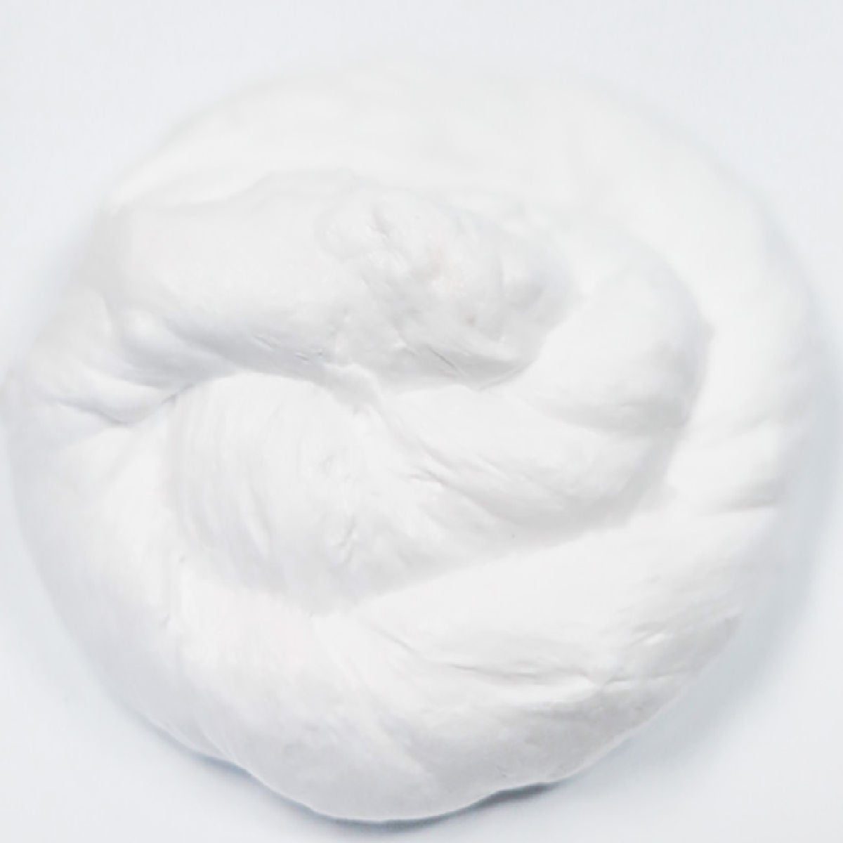 Snow Slime is so fun to make and only requires a few supplies. This is super easy and the kids will go crazy over this snow slime recipe. Pile of snow slime.