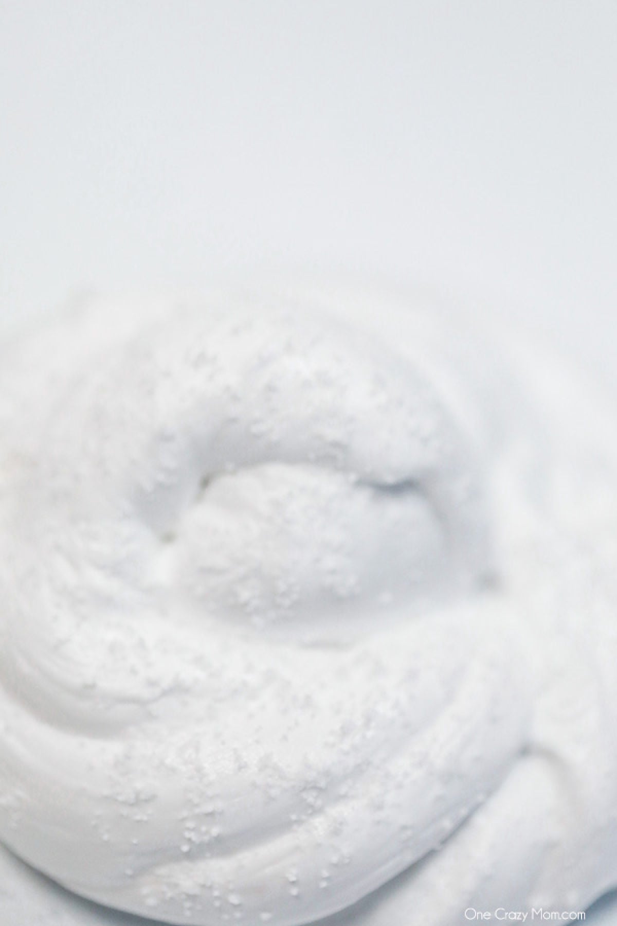 Snow Slime is so fun to make and only requires a few supplies. This is super easy and the kids will go crazy over this snow slime recipe. Pile of snow slime.