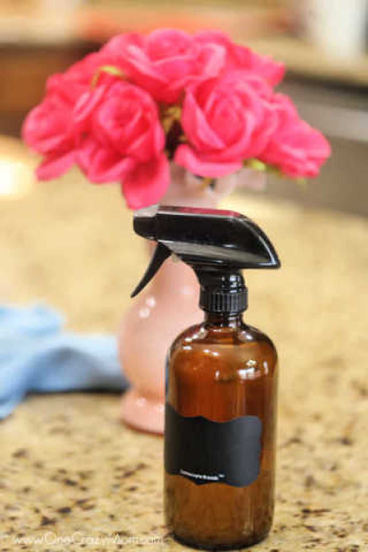 How to clean granite countertops easily with this Homemade Granite Cleaner. DIY granite cleane is easy and much cheaper than store bought granite cleaners. Bottle of granite cleaner on the counter.
