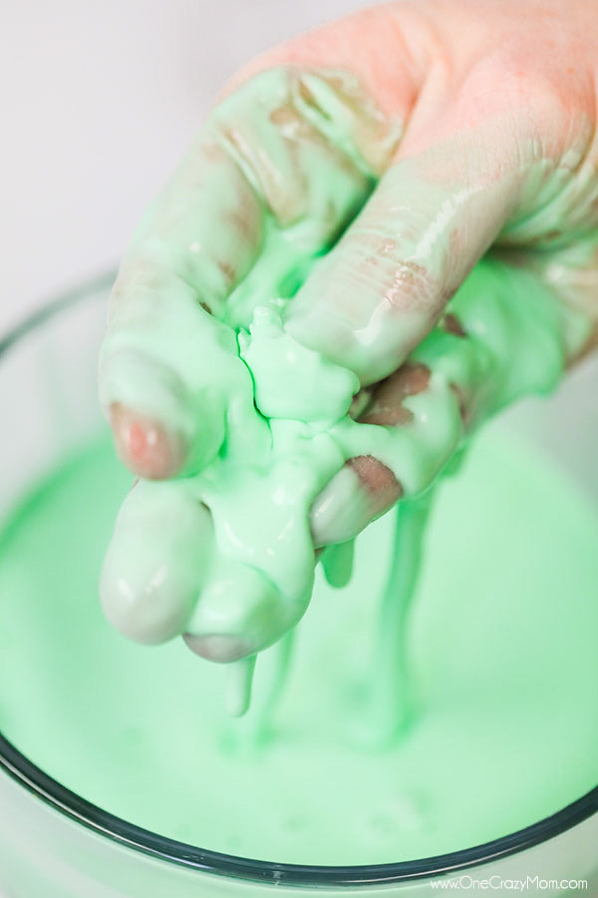 If your kids like to make slime, they will enjoy learning how to make oobleck. You only need 2 ingredients and this DIY doubles as a science experiment. Oobleck in bowl with a hand dipped in it.