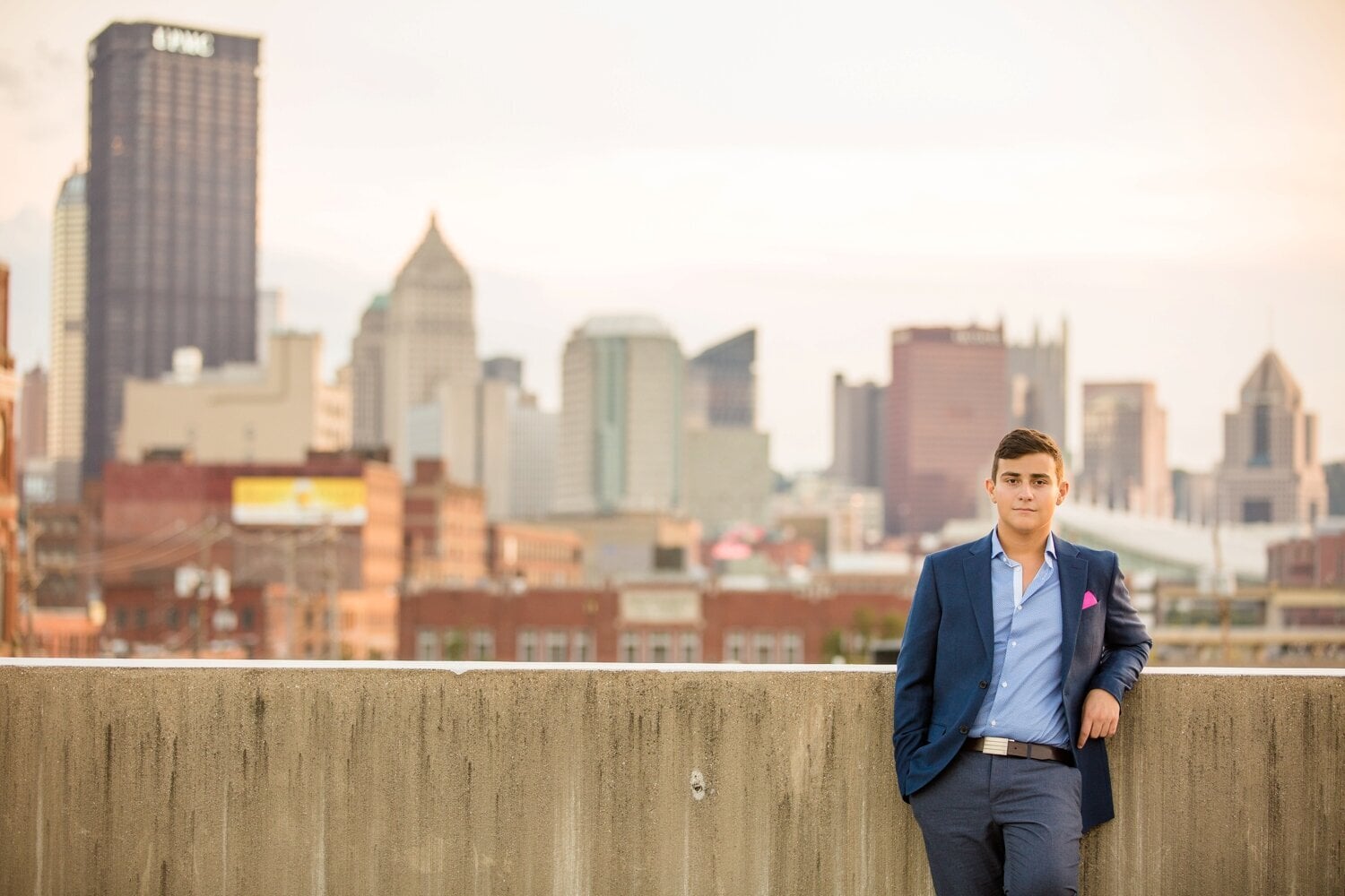 Boy in front of cityscape.