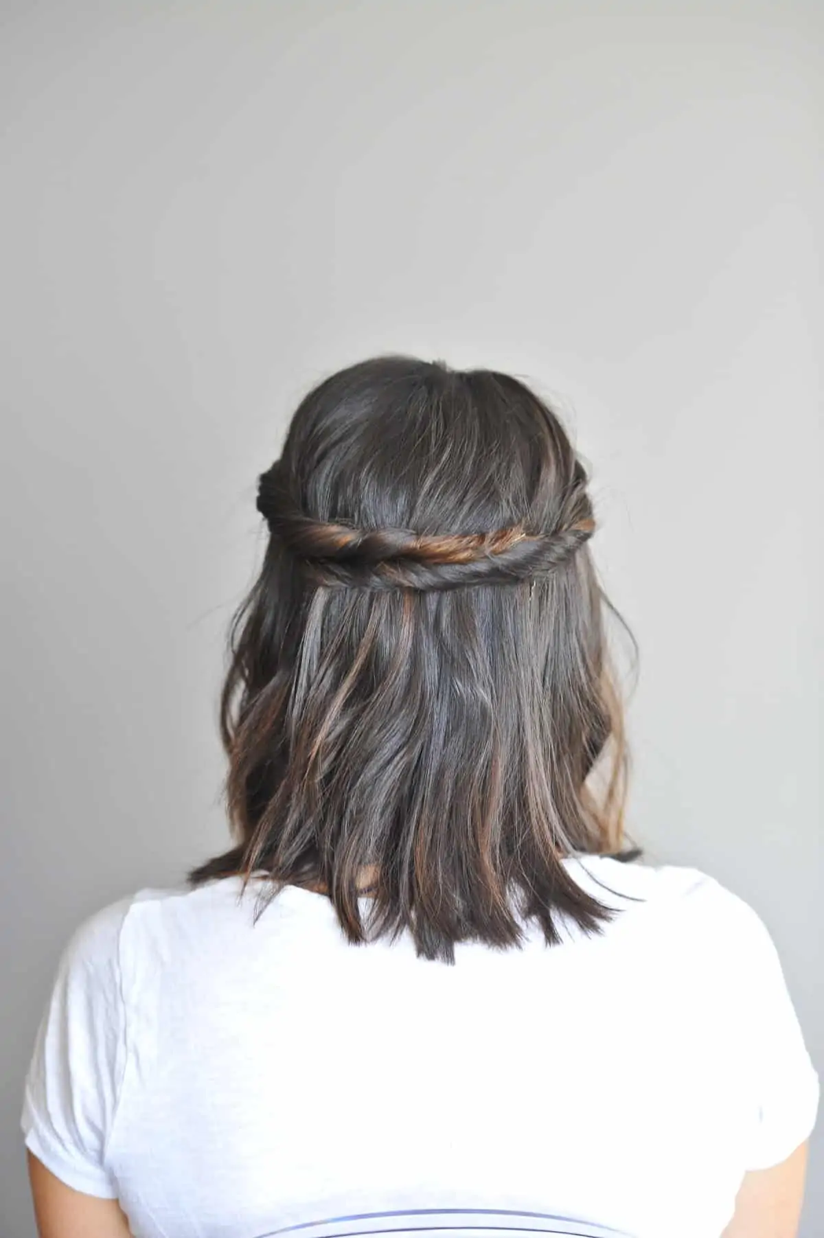 Twisted sister hairstyle on lady with dark hair.