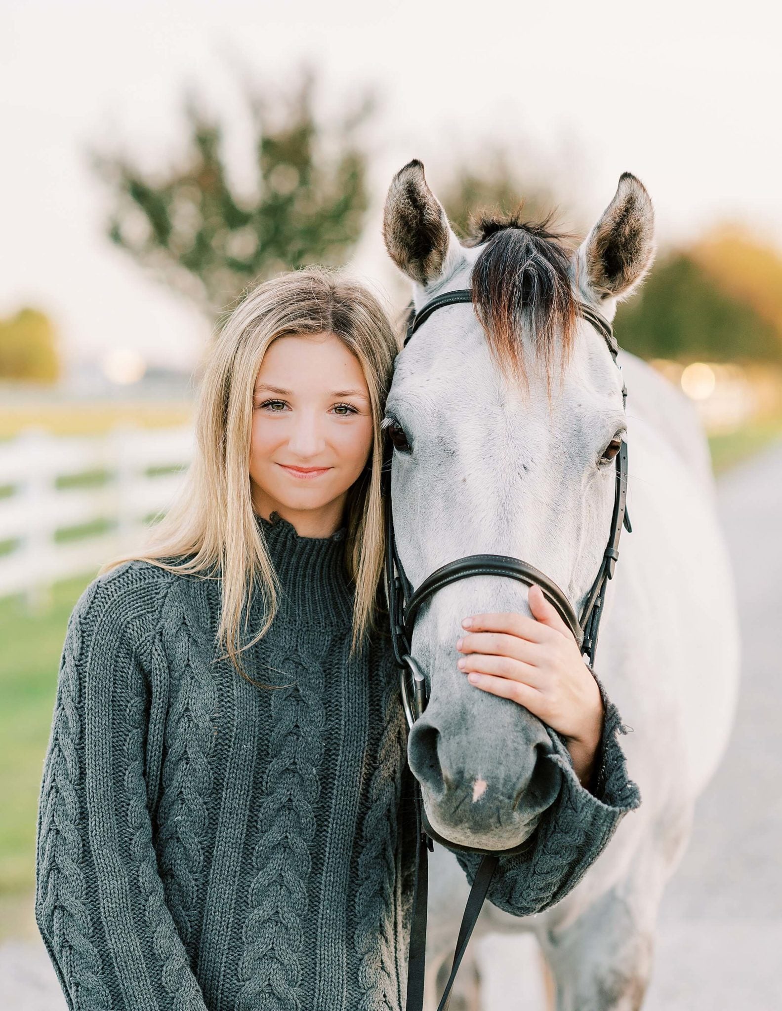 Girl standing with horse.