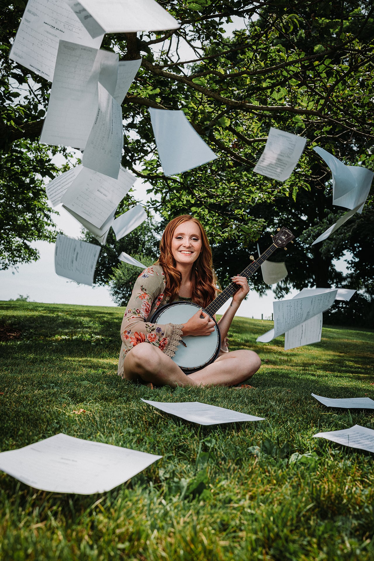 Girl playing banjo with music in the air.