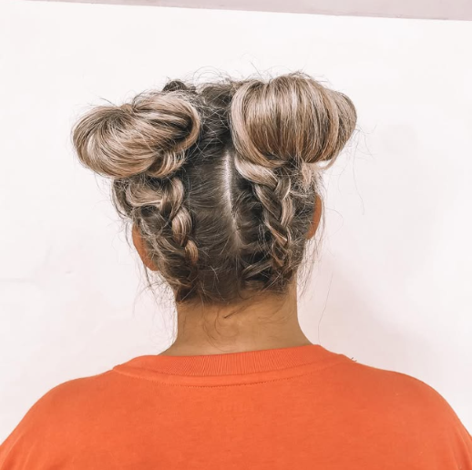 Space Bun on lady in orange shirt.